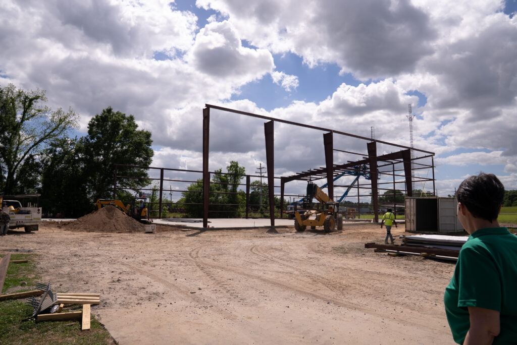 Missy Rogers watches the frame for Noble Plastics' new warehouse get installed.